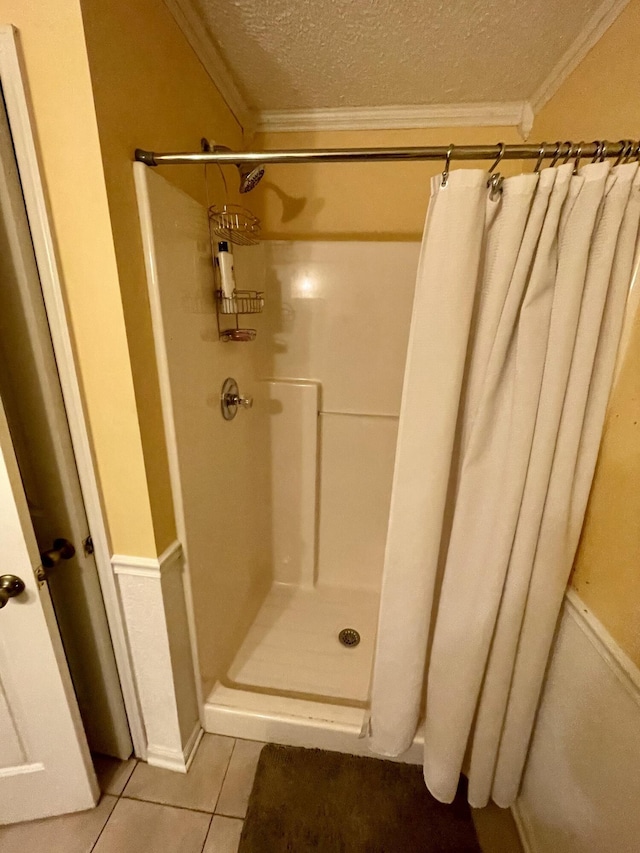412 Howard Cir, Chattanooga, TN 37411 - bathroom featuring crown molding, a shower stall, tile patterned flooring, and a textured ceiling
