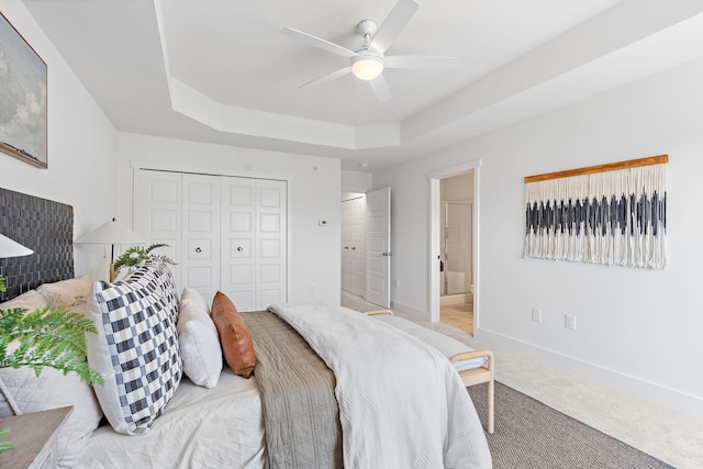 1108 Somerset Springs Dr, Spring Hill, TN 37174 - carpeted bedroom featuring a raised ceiling, ensuite bathroom, ceiling fan, and a closet