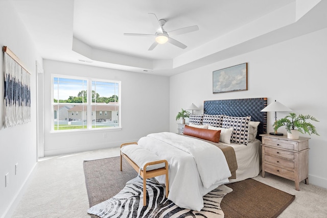 1108 Somerset Springs Dr, Spring Hill, TN 37174 - bedroom featuring a raised ceiling, light colored carpet, and a ceiling fan