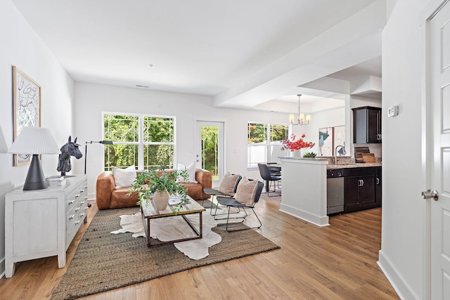 1108 Somerset Springs Dr, Spring Hill, TN 37174 - living area with light wood-type flooring and a chandelier
