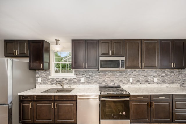 517 Danley Ct, Antioch, TN 37013 - kitchen with stainless steel appliances, dark brown cabinetry, and decorative backsplash