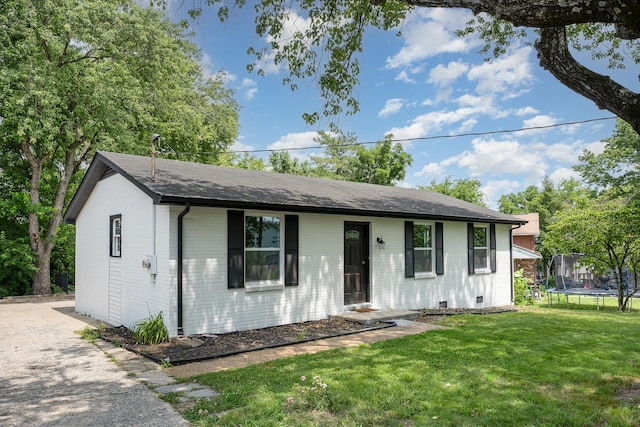 517 Danley Ct, Antioch, TN 37013 - ranch-style house with a trampoline, brick siding, a front lawn, and roof with shingles