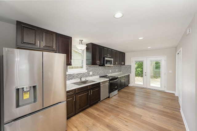517 Danley Ct, Antioch, TN 37013 - kitchen with appliances with stainless steel finishes, decorative backsplash, light wood-type flooring, recessed lighting, and dark brown cabinetry