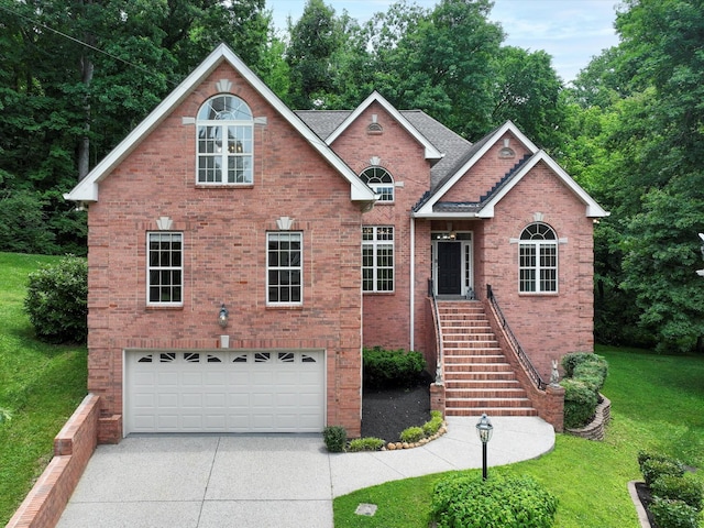 5012 Tulip Grove Ln, Hermitage, TN 37076 - traditional-style home with an attached garage, driveway, brick siding, and a front lawn