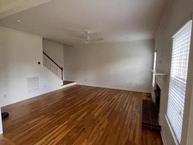 2010 Katach Ct, Spring Hill, TN 37174 - unfurnished living room with stairs, wood finished floors, a ceiling fan, crown molding, and healthy amount of natural light