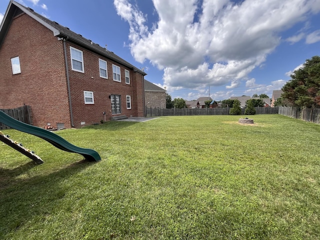 2010 Katach Ct, Spring Hill, TN 37174 - fenced backyard featuring a playground and a fire pit