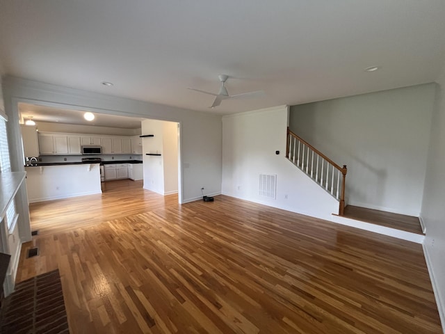 2010 Katach Ct, Spring Hill, TN 37174 - unfurnished living room featuring light wood-style floors, stairs, and ceiling fan