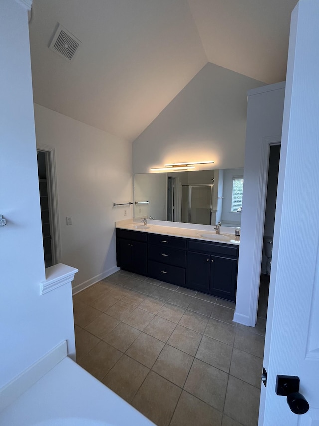 2010 Katach Ct, Spring Hill, TN 37174 - full bathroom featuring tile patterned flooring, lofted ceiling, double vanity, and a shower with shower door