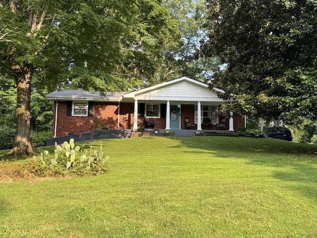 203 Grandview Dr, Dickson, TN 37055 - view of front facade with covered porch, a front lawn, and brick siding