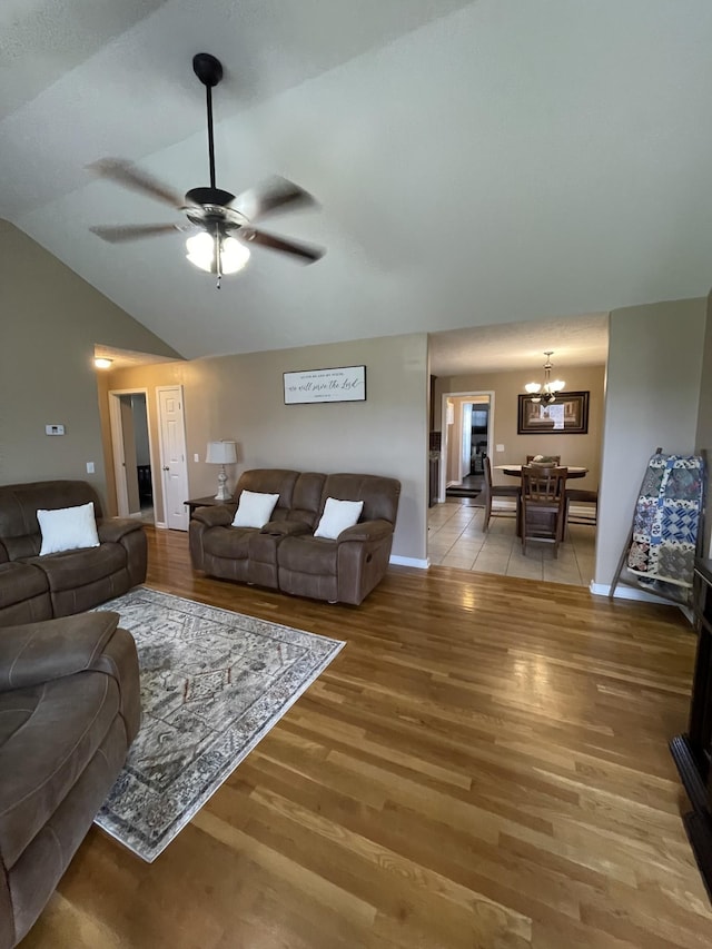 532 Douglas Ln, Lafayette, TN 37083 - living room featuring lofted ceiling, a chandelier, light wood-style flooring, and ceiling fan