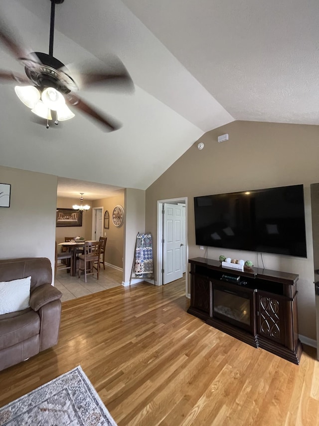 532 Douglas Ln, Lafayette, TN 37083 - living area with light wood-style flooring, lofted ceiling, a ceiling fan, and a chandelier
