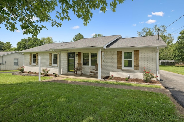 1710 New Highway 7, Columbia, TN 38401 - ranch-style home featuring brick siding, a front yard, a porch, and a shingled roof