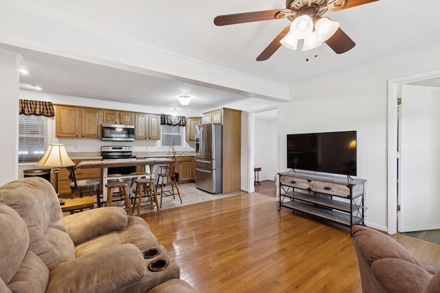 1710 New Highway 7, Columbia, TN 38401 - living room with light wood finished floors, a ceiling fan, and ornamental molding