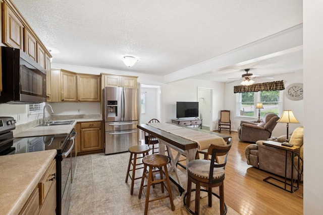 1710 New Highway 7, Columbia, TN 38401 - kitchen with stainless steel fridge with ice dispenser, range with electric stovetop, light countertops, a ceiling fan, and a textured ceiling