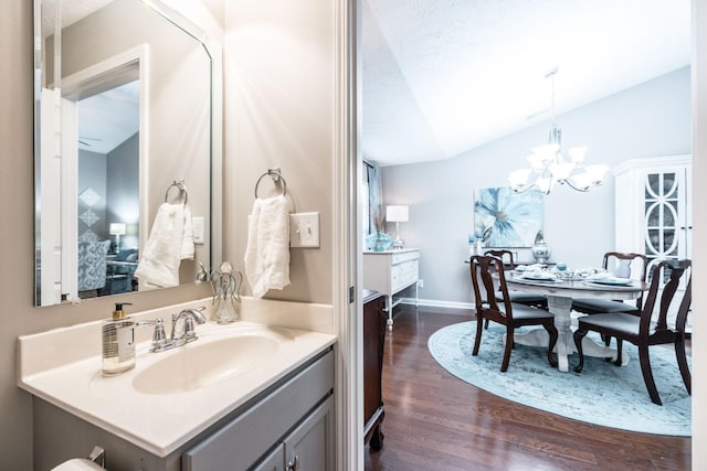 395 Devon Chase Hl Unit 3002, Gallatin, TN 37066 - bathroom with wood finished floors, a chandelier, vanity, vaulted ceiling, and a textured ceiling
