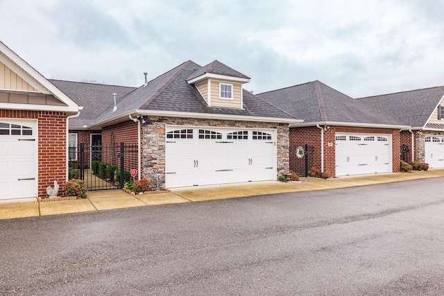 395 Devon Chase Hl Unit 3002, Gallatin, TN 37066 - view of front of house with board and batten siding, stone siding, a shingled roof, and an attached garage