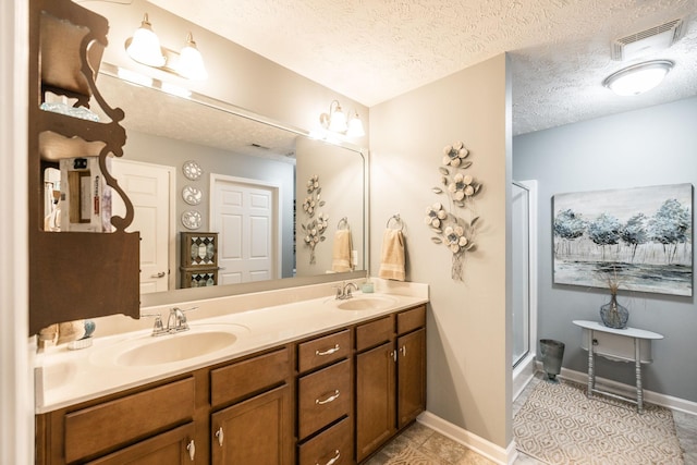 395 Devon Chase Hl Unit 3002, Gallatin, TN 37066 - bathroom featuring double vanity, a stall shower, a textured ceiling, and tile patterned floors