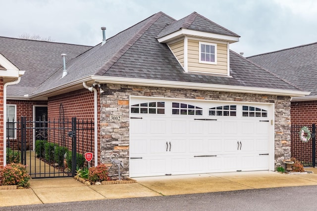 395 Devon Chase Hl Unit 3002, Gallatin, TN 37066 - view of front of property with stone siding, roof with shingles, an attached garage, and a gate