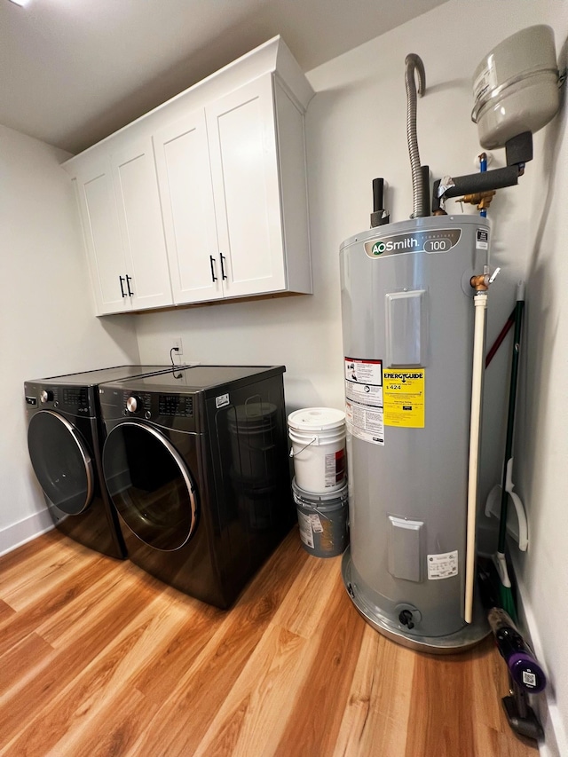 543 2nd Ave N, Lewisburg, TN 37091 - laundry room with water heater, washer and dryer, light wood-style floors, and cabinet space