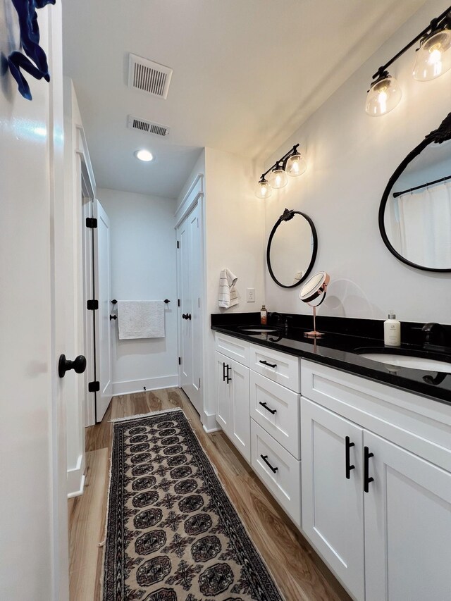 543 2nd Ave N, Lewisburg, TN 37091 - full bathroom featuring double vanity and wood finished floors