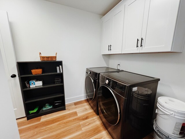 543 2nd Ave N, Lewisburg, TN 37091 - laundry area with washer and clothes dryer, cabinet space, and light wood finished floors