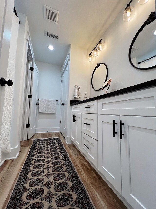 543 2nd Ave N, Lewisburg, TN 37091 - bathroom featuring double vanity, wood finished floors, and recessed lighting