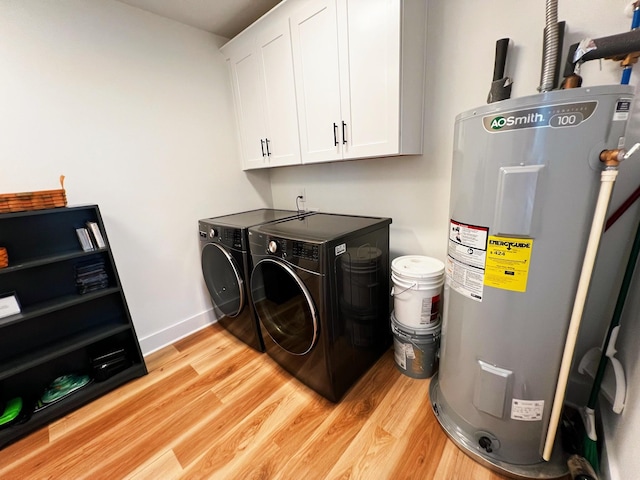 543 2nd Ave N, Lewisburg, TN 37091 - laundry room featuring electric water heater, cabinet space, washer and dryer, and light wood-style flooring