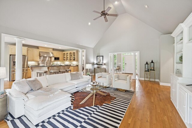 1387 Floyd Rd, Eagleville, TN 37060 - living room featuring high vaulted ceiling, ceiling fan, light wood-style flooring, decorative columns, and recessed lighting