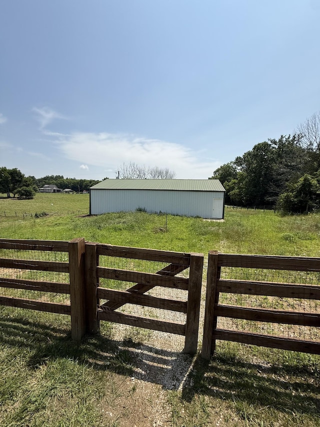 1387 Floyd Rd, Eagleville, TN 37060 - gate with a pole building, an outdoor structure, and a rural view