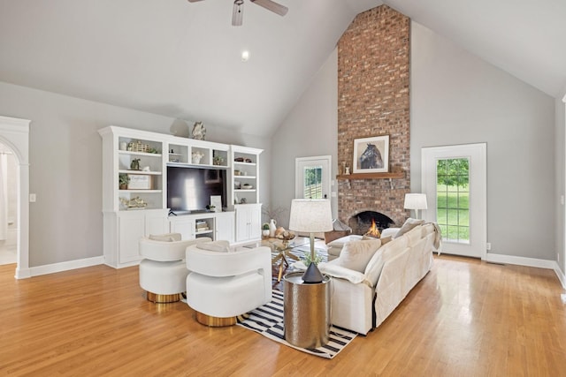 1387 Floyd Rd, Eagleville, TN 37060 - living area featuring high vaulted ceiling, a fireplace, light wood-style flooring, and a ceiling fan