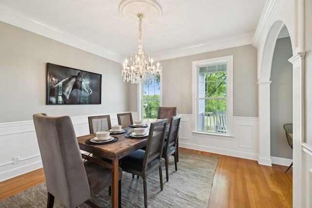 1387 Floyd Rd, Eagleville, TN 37060 - dining space with light wood-type flooring, a chandelier, wainscoting, ornamental molding, and decorative columns