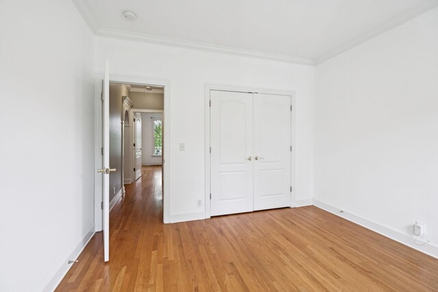 1387 Floyd Rd, Eagleville, TN 37060 - unfurnished bedroom with ornamental molding, light wood-type flooring, and a closet