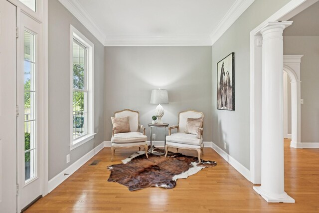 1387 Floyd Rd, Eagleville, TN 37060 - living area featuring ornate columns, plenty of natural light, crown molding, and light wood finished floors