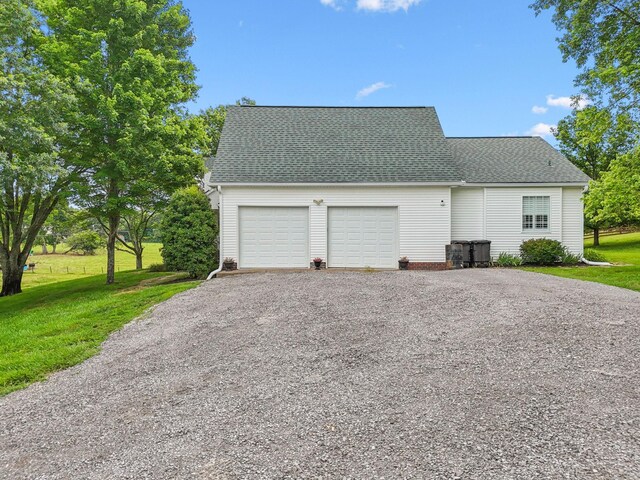 1387 Floyd Rd, Eagleville, TN 37060 - view of side of home featuring a garage, gravel driveway, a lawn, and roof with shingles