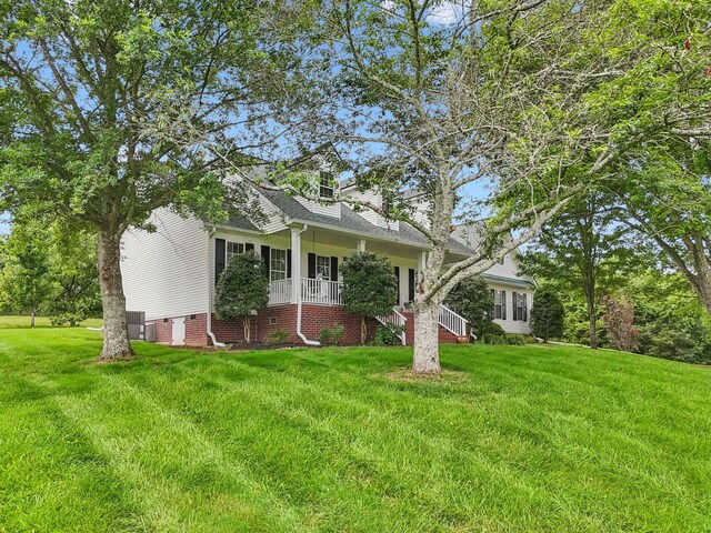1387 Floyd Rd, Eagleville, TN 37060 - view of front of house featuring a front yard and roof with shingles