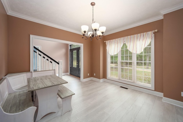 118 Stonebridge, Selmer, TN 38375 - unfurnished dining area featuring a chandelier, stairway, crown molding, light wood-style floors, and healthy amount of natural light