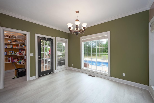 118 Stonebridge, Selmer, TN 38375 - unfurnished dining area featuring a chandelier, crown molding, and light wood finished floors