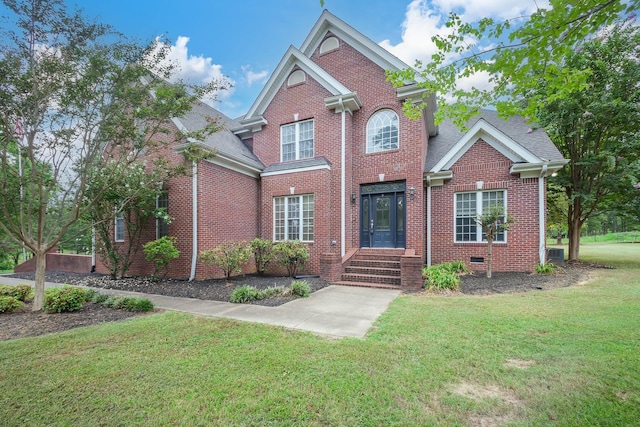 118 Stonebridge, Selmer, TN 38375 - traditional-style house featuring brick siding, a front yard, and roof with shingles