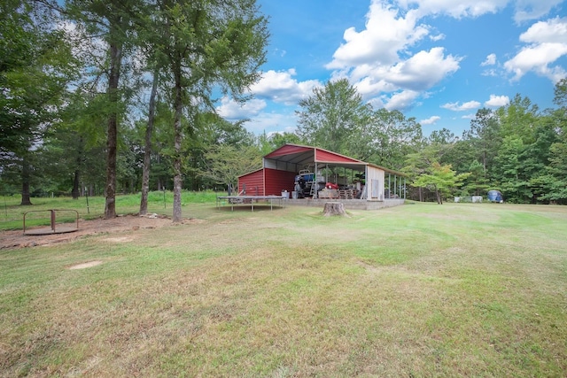 118 Stonebridge, Selmer, TN 38375 - view of green lawn with a detached carport, a pole building, and an outdoor structure