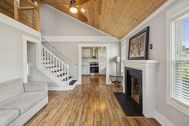 410 Campbell Ave, Tullahoma, TN 37388 - unfurnished living room with a fireplace with flush hearth, wooden ceiling, wood finished floors, vaulted ceiling, and stairway