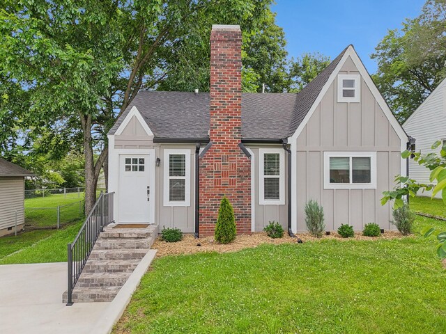 410 Campbell Ave, Tullahoma, TN 37388 - view of front of house with board and batten siding, a shingled roof, and a chimney