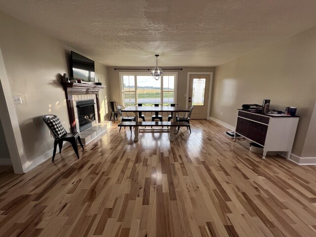 11 Jess Long Ln, Hillsboro, TN 37342 - dining room featuring wood finished floors, a textured ceiling, and a fireplace