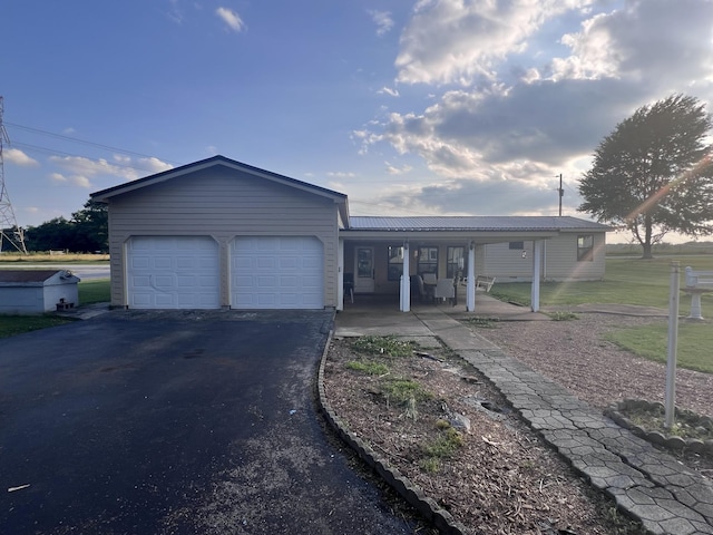 11 Jess Long Ln, Hillsboro, TN 37342 - view of front of property featuring an attached garage, asphalt driveway, a metal roof, and covered porch