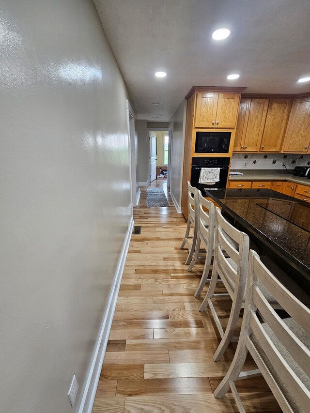 11 Jess Long Ln, Hillsboro, TN 37342 - kitchen featuring black appliances, recessed lighting, light wood-style floors, and dark countertops