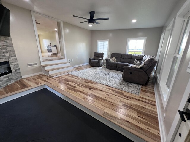 11 Jess Long Ln, Hillsboro, TN 37342 - living room with wood finished floors, ceiling fan, a stone fireplace, and recessed lighting