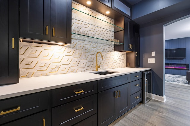 6826 Falls Ridge Ln, College Grove, TN 37046 - indoor wet bar featuring beverage cooler, tasteful backsplash, and light wood finished floors