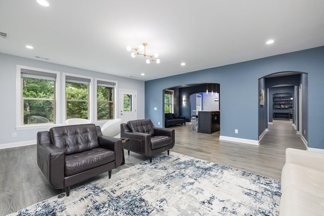 6826 Falls Ridge Ln, College Grove, TN 37046 - living area with arched walkways, a chandelier, wood finished floors, and recessed lighting