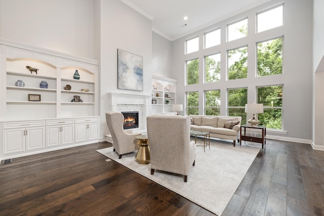 6826 Falls Ridge Ln, College Grove, TN 37046 - living area featuring a high ceiling, a fireplace, dark wood-style floors, ornamental molding, and built in features