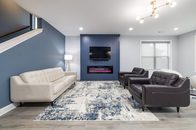 6826 Falls Ridge Ln, College Grove, TN 37046 - living area with a large fireplace, wood finished floors, recessed lighting, and a chandelier