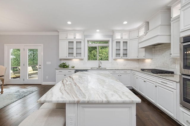 6826 Falls Ridge Ln, College Grove, TN 37046 - kitchen with stainless steel appliances, plenty of natural light, a kitchen island, white cabinetry, and ornamental molding
